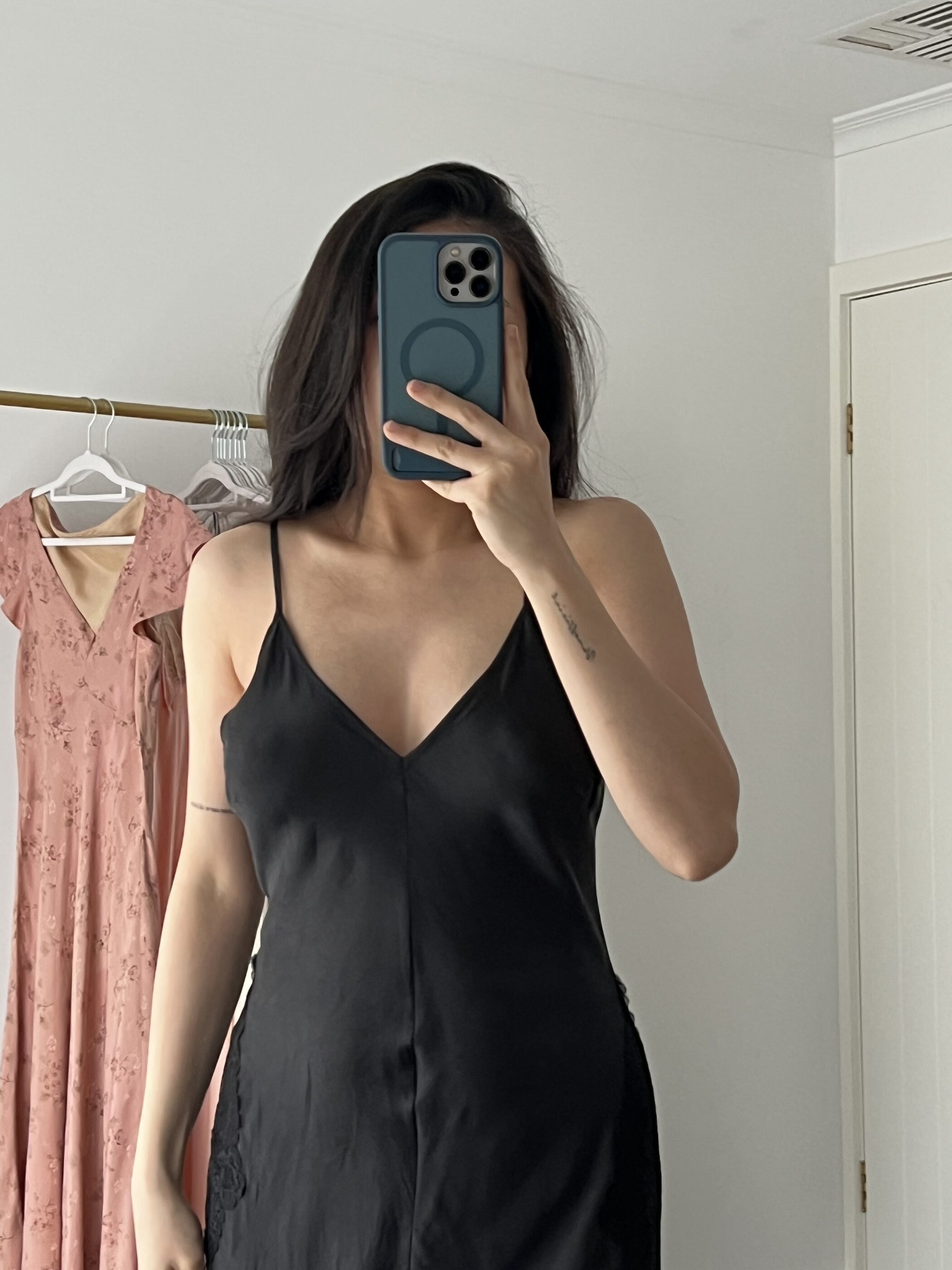 The black gown worn, closer, with its deep V neckline