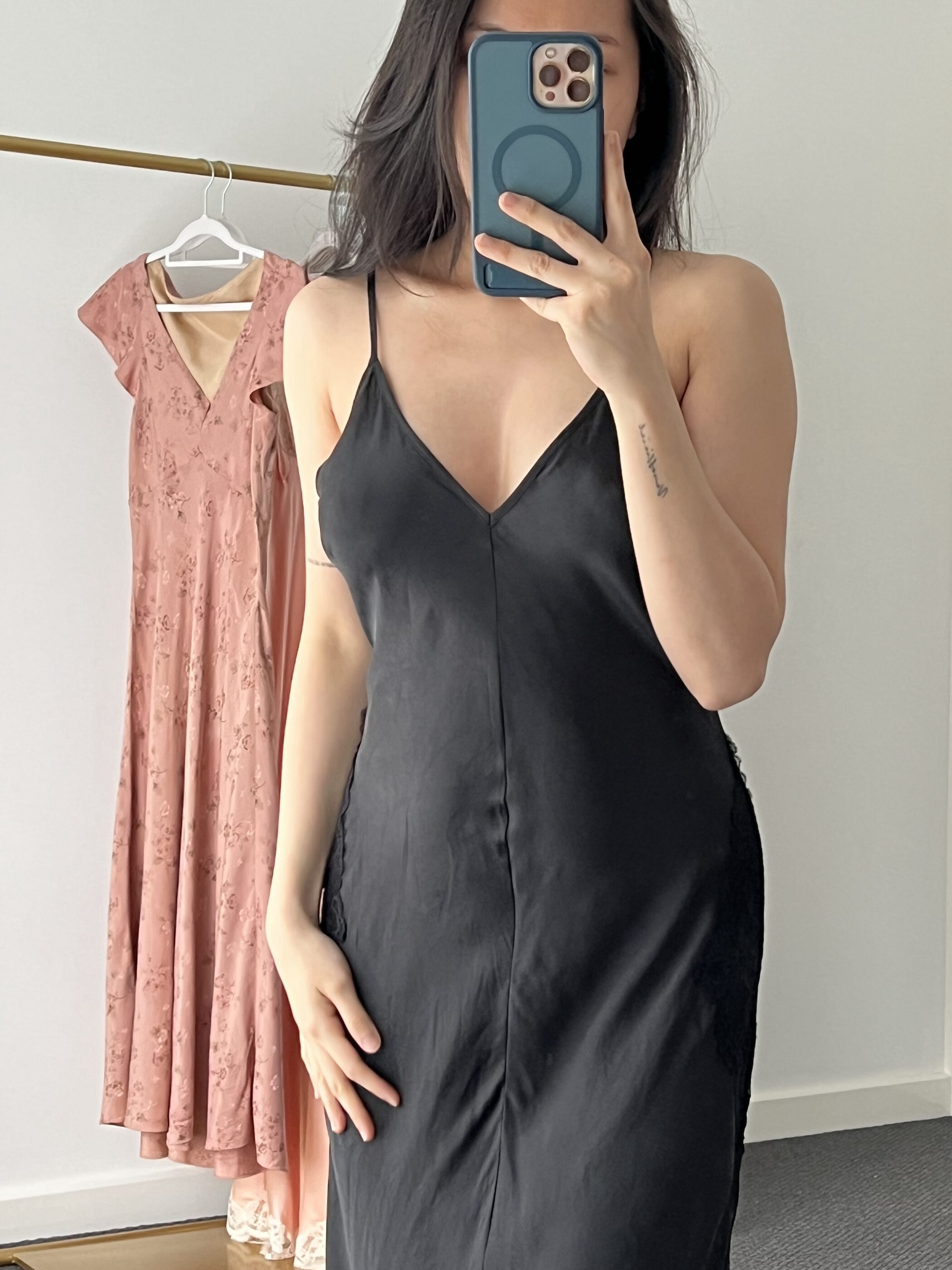 The bodice and fine straps of the black gown