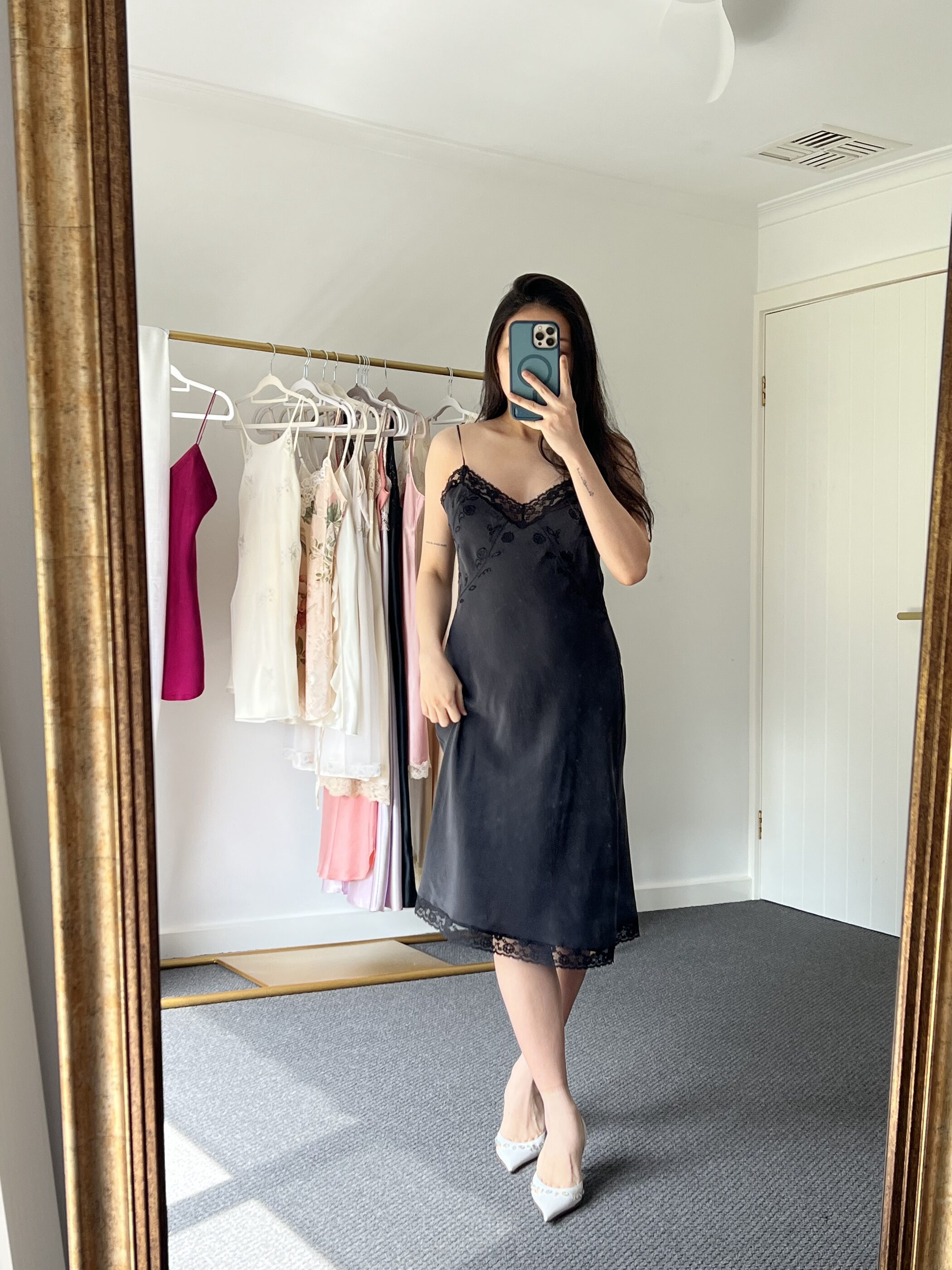 The black lace slip to mid-calf, worn with ivory heels
